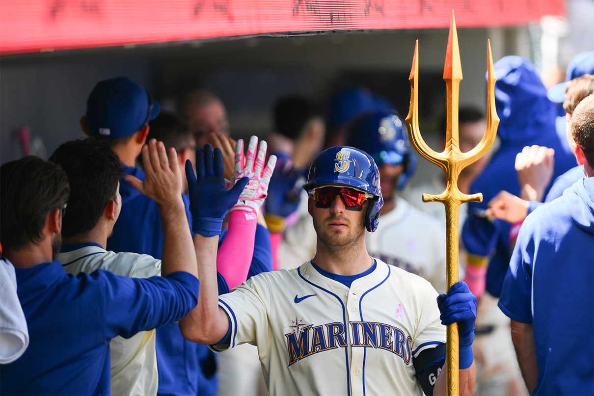 May 12, 2024; Seattle, Washington, USA; Seattle Mariners designated hitter Mitch Garver (18) celebrates in the dugout after hitting a 2-run home run against the Oakland Athletics during the fifth inning at T-Mobile Park. Mandatory Credit: Steven Bisig-USA TODAY Sports